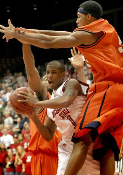 
Mac Hopson splits Texas-San Antonio defenders to get off a pass in Cougars' 67-44 win Friday.  
 (BRUCE TWITCHELL Special to / The Spokesman-Review)