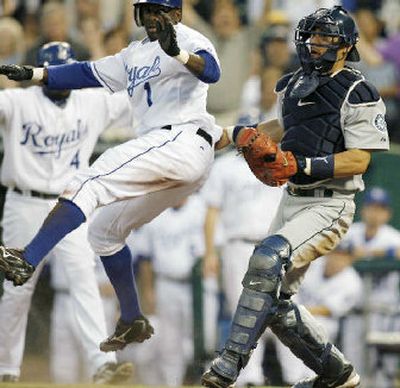 
Kansas City's Joey Gathright scoots past Seattle catcher Kenji Johjima to score in the fourth inning on Saturday. 
 (Associated Press / The Spokesman-Review)