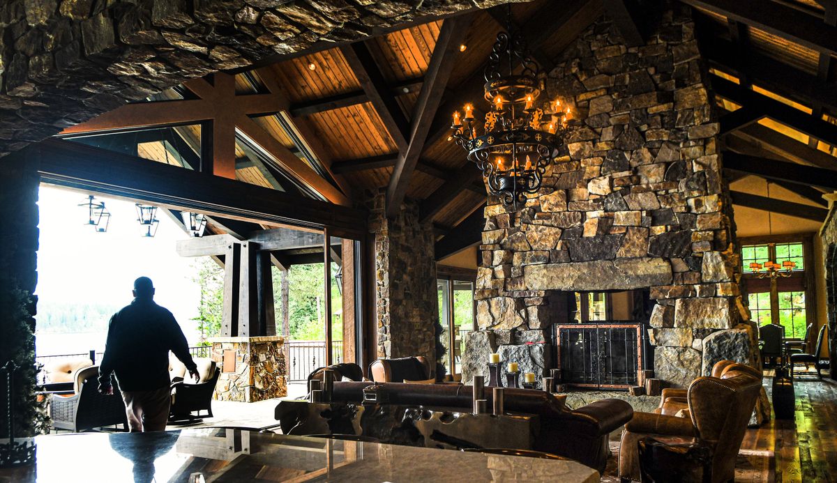 Greg Rowley, Broker with Coldwell Banker Schneidmiller Realty, walks through the $27 million Copper Rock Estate on Lake Coeur d’Alene on Wednesday.  (Kathy Plonka/The Spokesman-Review)