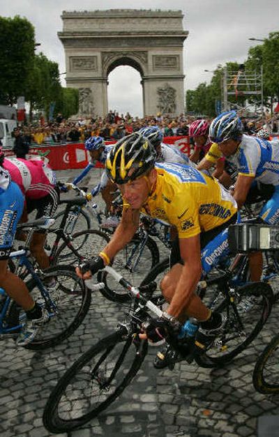
Lance Armstrong rides by the Arc de Triomphe on his way to his seventh Tour win. 
 (Associated Press / The Spokesman-Review)