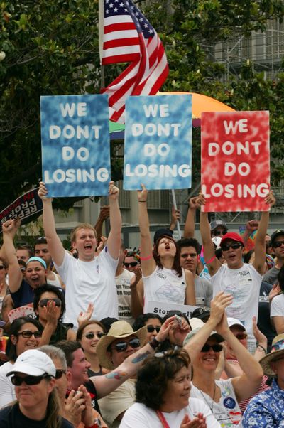 Protesters hold signs during  a rally Saturday in Fresno, Calif., to protest the state Supreme Court decision to uphold Proposition 8.  (Associated Press / The Spokesman-Review)