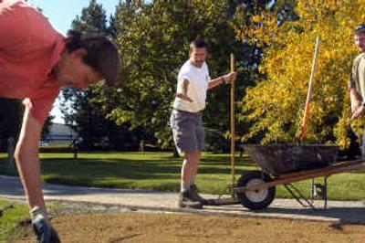 
Jim Haynes, treasurer of Green Zone, discusses the layout of a flower bed with Ben Peterson, a Spokane County Conservation District employee, while Green Zone president Carol Albietz works in the foreground. Green Zone will host an educational festival this weekend to show homeowners how to have an environmentally friendly lawn.
 (Jed Conklin / The Spokesman-Review)