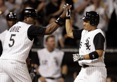 
Juan Uribe, left, congratulates Tadahito Iguchi after his go-ahead, three-run homer in the fifth inning off David Wells launched the Chicago White Sox toward a 5-4 win over the Boston Red Sox on Wednesday. 
 (Associated Press / The Spokesman-Review)