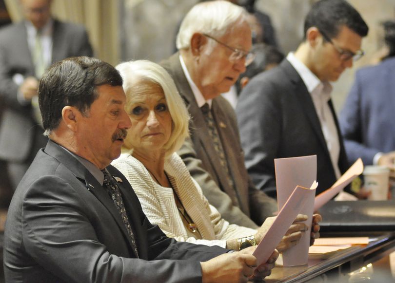 OLYMPIA -- Senate Majority Leader Mark Schoesler, left, with Sens. Randi Becker, Jim Honeyford and Joe Fain, go over a list of bills for the Senate to consider Tuesday. (Jim Camden/The Spokesman-Review)