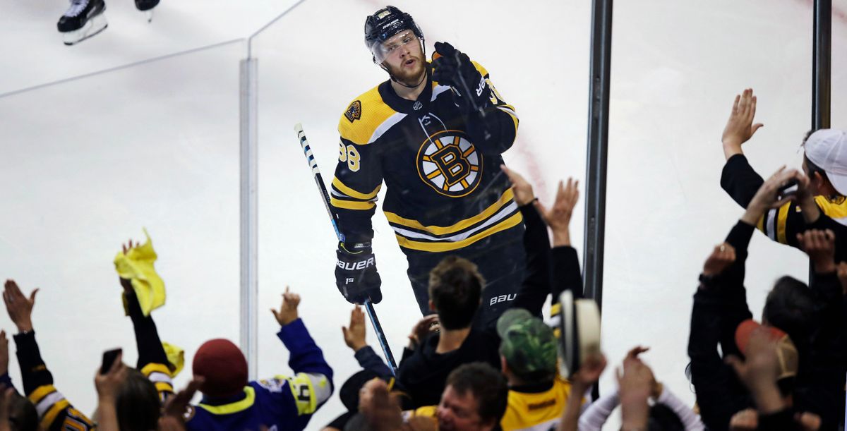 Boston Bruins right wing David Pastrnak celebrates with fans after his goal off Toronto Maple Leafs goaltender Frederik Andersen during the third period of Game 7 of an NHL hockey first-round playoff series in Boston, Wednesday, April 25, 2018. (Charles Krupa / Associated Press)