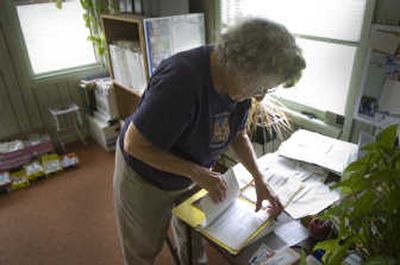 
Helen Boots, of Cheney, works at her desk Monday and remembers the damage done to an old Indian cemetery south of Cheney. 
 (Christopher Anderson / The Spokesman-Review)