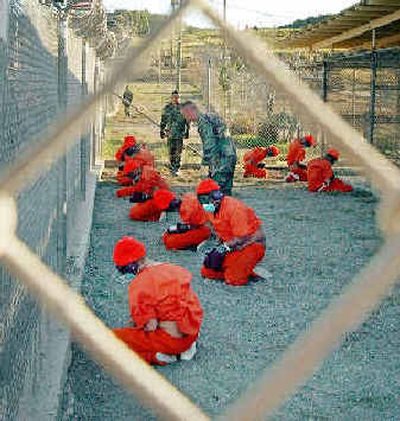 
Taliban and al Qaeda detainees sit in a holding area at Camp X-Ray at Guantanamo Bay, Cuba, during in-processing to the temporary detention facility in 2002. Taliban and al Qaeda detainees sit in a holding area at Camp X-Ray at Guantanamo Bay, Cuba, during in-processing to the temporary detention facility in 2002. 
 (Associated PressAssociated Press / The Spokesman-Review)