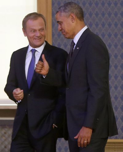 President Barack Obama gives a thumbs-up as he walks and talks with Polish Prime Minister Donald Tusk before they spoke to reporters in Warsaw, Poland, Tuesday. (Associated Press)