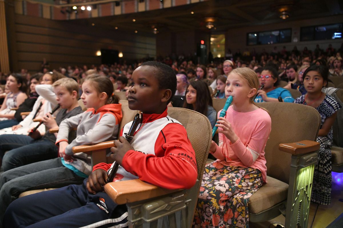 Fourth-graders from Adams Elementary, including Mohamed Gan, center, and hundreds of other fourth-graders from around Spokane, wait their turns to sing and play with the Spokane Symphony Orchestra and a jazz combo at a program called Symphony Swings Tuesday, May 1, 2018 at the Martin Woldson Theater at the Fox. Fourth-graders from around Spokane participated in a symphony program developed by Carnegie Halls Weill Institute of Music where teachers have the kids learn to play the recorder and sing songs that were part of the Tuesdays program, which focused on jazz music and rhythms. (Jesse Tinsley / The Spokesman-Review)
