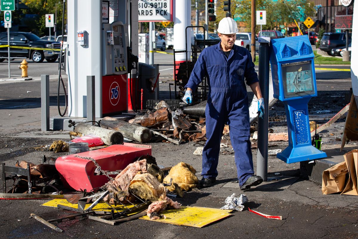 An investigation team from Spokane Fire Department processes a scene at a 76 gas station located at Second and Walnut in Spokane on Oct. 1, 2019. Last night, SWAT was in an hours long standoff with a suspect who allegedly pointed a gun at a state trooper and fled to the gas station, where he then barricaded himself inside and was said to have set fire to the building. (Libby Kamrowski / The Spokesman-Review)