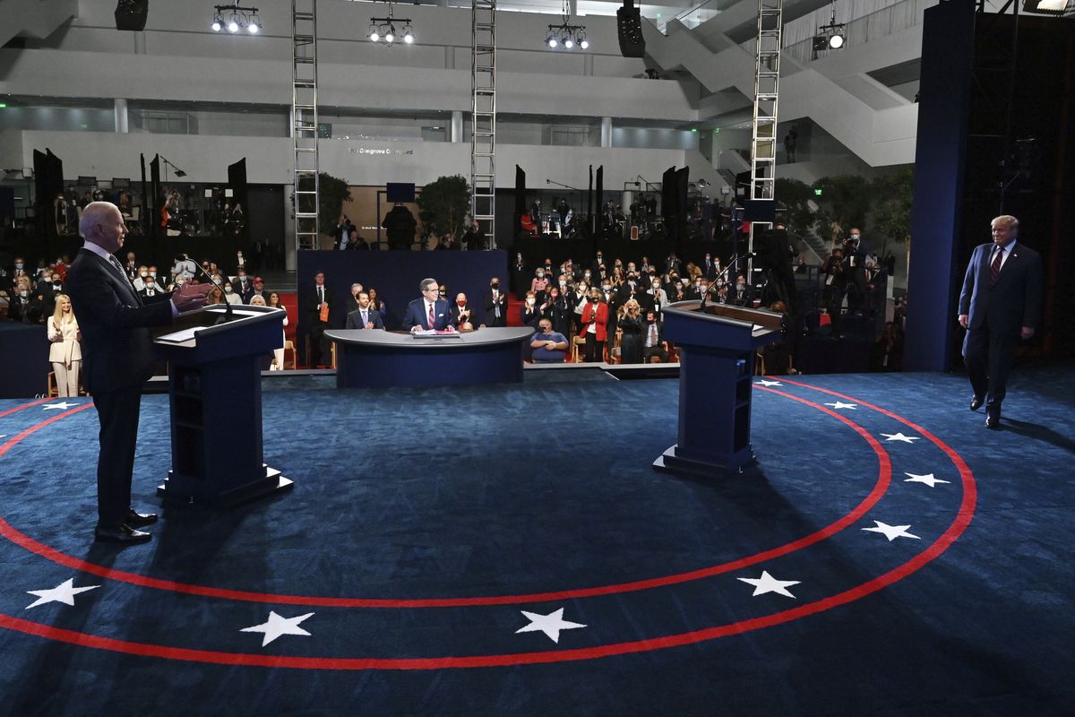 Democratic presidential candidate former Vice President Joe Biden gestures as President Donald Trump walks onto stage for the first presidential debate Tuesday, Sept. 29, 2020, at Case Western University and Cleveland Clinic, in Cleveland.  (Olivier Douliery)