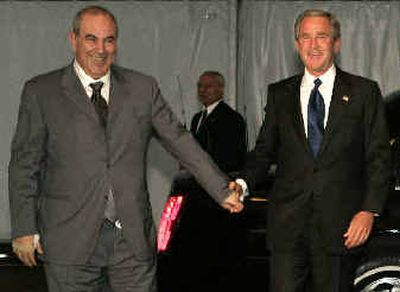 President   Bush walks with Iraqi interim Prime Minister Ayad Allawi after they arrived at the United Nations on Tuesday. U.S. Secretary of State Colin Powell is seen at the rear. 
 (Associated Press / The Spokesman-Review)