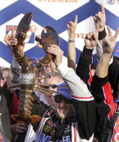 Tony Stewart holds up a lobster after winning Sunday at New Hampshire Motor Speedway. (Associated Press)