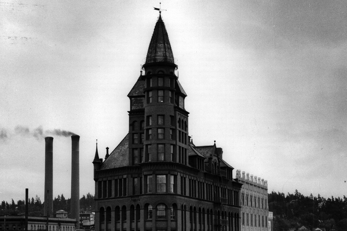 The 1891 Review Tower, designed by architect Chauncey Seaton and seen here in a 1954 photo, was built by the Spokane Falls Review’s owners Harvey W. Scott and Henry L. Pittock, both Oregon newspapermen, and Spokane businessman Anthony M. Cannon. It is flanked on the left by the 1888 Crescent building and on the right by the 1927 Chronicle building. (SR)