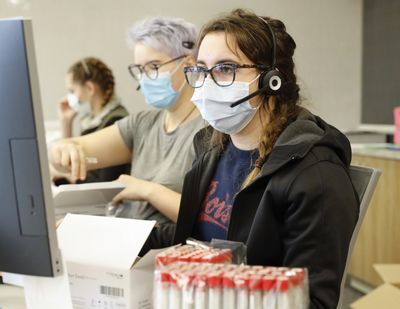 Employees schedule COVID-19 tests and prepare test kits on Nov. 24 at Primary Health Medical Group’s clinic in Boise.  (Courtesy of Otto Kitsinger)