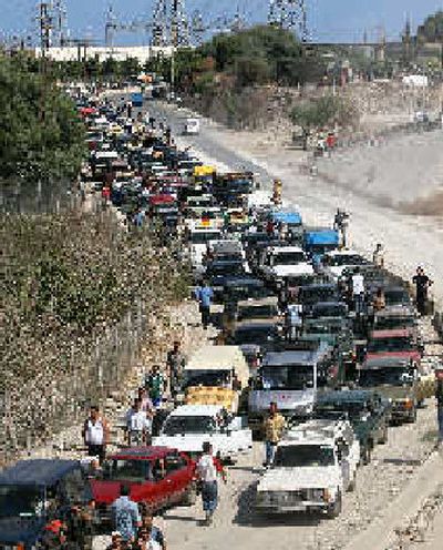 
Displaced Lebanese stream back into southern Lebanon Monday. 
 (Associated Press / The Spokesman-Review)