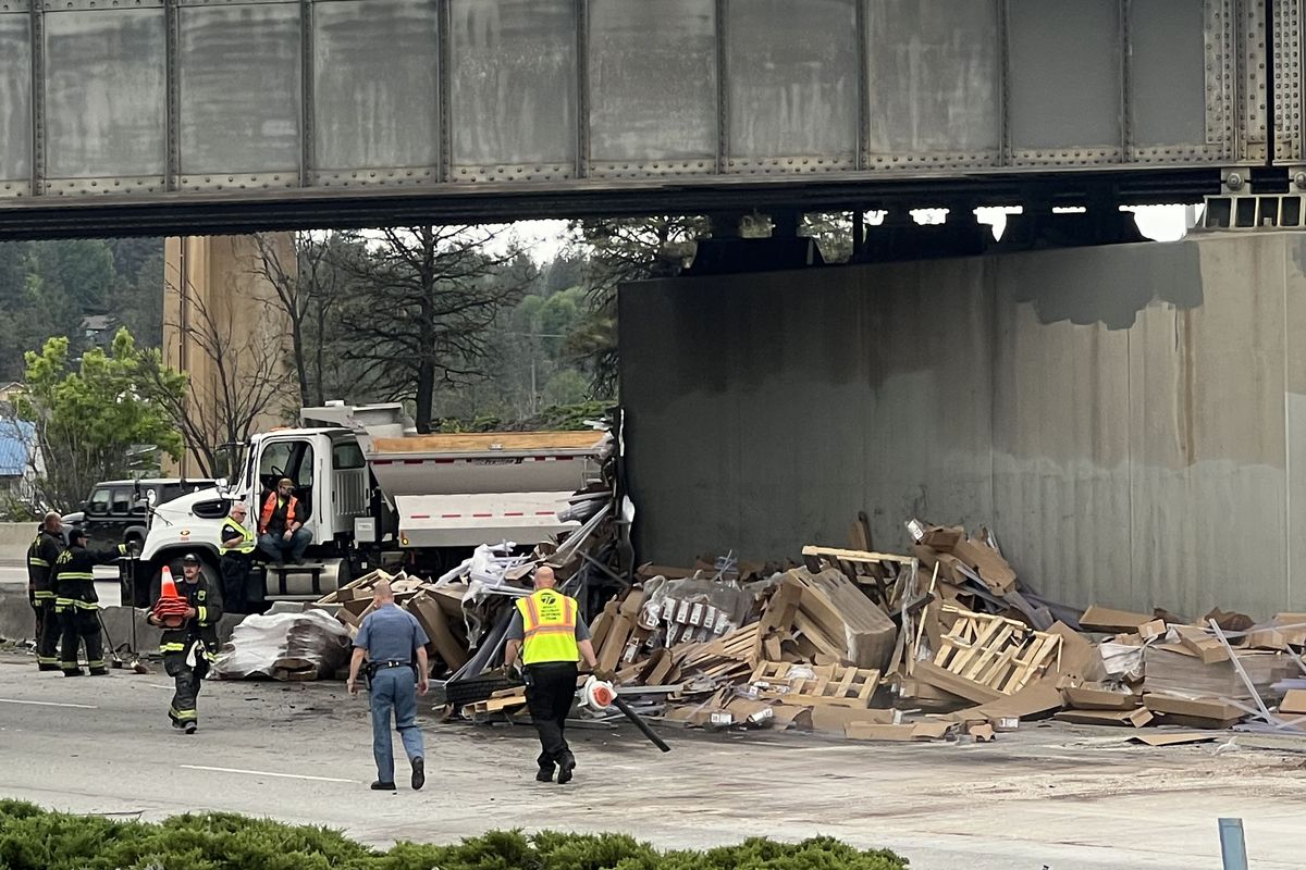Pallets and other items spilled under a railroad bridge from an eastbound semitruck that tipped on its side Wednesday morning on Interstate 90 just east of where the freeway passes over Latah Creek.  (Jonathan Brunt/The Spokesman-Review)