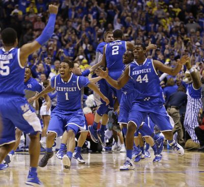 Kentucky players celebrate after Aaron Harrison made a 3-pointer with 2.3 seconds left to lift the Wildcats over Michigan. (Associated Press)