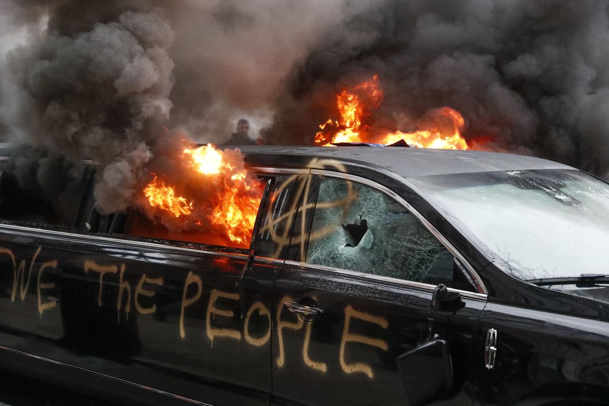 A parked limousine burns during a demonstration after the inauguration of President Donald Trump, Friday, Jan. 20, 2017, in Washington. Protesters registered their rage against the new president Friday in a chaotic confrontation with police who used pepper spray and stun grenades in a melee just blocks from Donald Trump