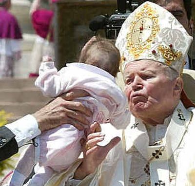 
Pope John Paul II is handed a baby for a blessing in St. Peter's Square at the Vatican during a canonization ceremony on Sunday. Pope John Paul II is handed a baby for a blessing in St. Peter's Square at the Vatican during a canonization ceremony on Sunday. 
 (Associated PressAssociated Press / The Spokesman-Review)