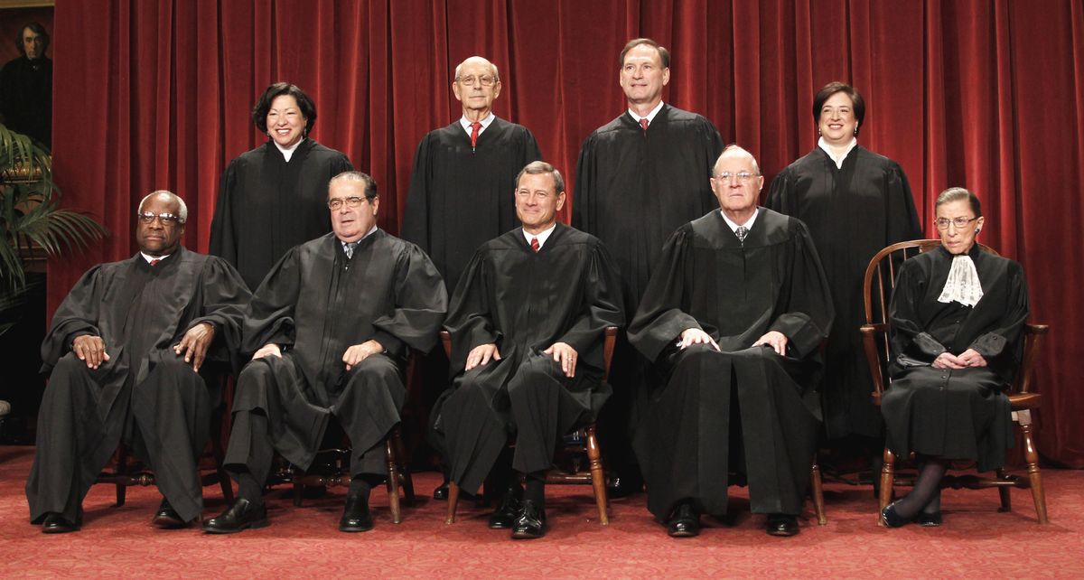 FILE -In this Oct. 8, 2010 file photo justices of the U.S. Supreme Court gather for a group portrait at the Supreme Court in Washington. Seated from left are Associate Justices Clarence Thomas, and Antonin Scalia, Chief Justice John Roberts, Associate Justices Anthony M. Kennedy, and Ruth Bader Ginsburg. Standing, from left are Associate Justices Sonia Sotomayor, Stephen Breyer, Samuel Alito Jr., and Elena Kagan. The nine justices of the Supreme Court, who serve without seeking election, soon will have to decide whether to insert themselves into the center of the nation