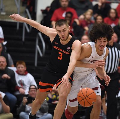 Oregon State forward Tres Tinkle (3) and Washington State forward CJ Elleby (2) chase a loose ball during a college basketball game, Sat., Jan. 18, 2020, in Pullman, Wash. (Colin Mulvany / The Spokesman-Review)