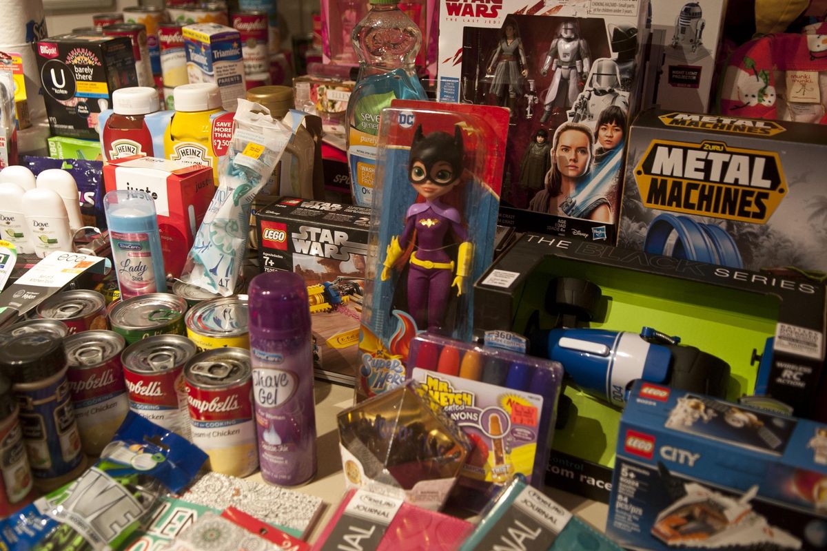 Donated items are photographed at the Electric Age Tattoo in Coeur d’Alene during its charity drive for the Children’s Village on Friday. (Kathy Plonka / The Spokesman-Review)