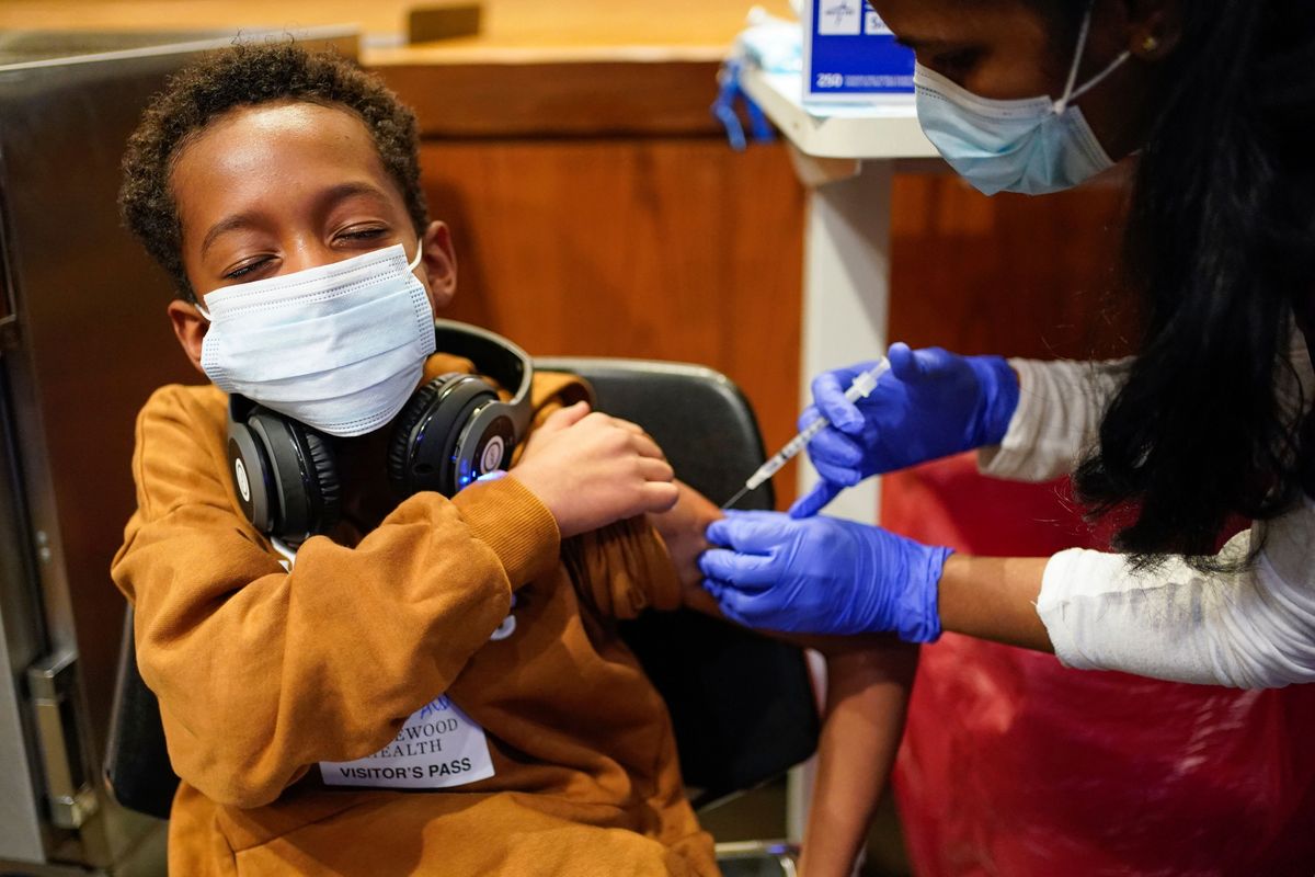 FILE - Cameron West, 9, receives a COVID-19 vaccination at Englewood Health in Englewood, N.J., Monday, Nov. 8, 2021. Health systems have released little data on the racial breakdown of youth vaccinations, and community leaders fear that Black and Latino kids are falling behind.  (Seth Wenig)