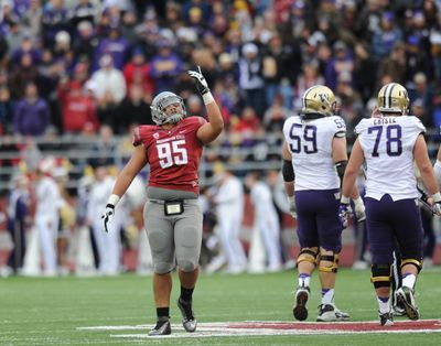 Washington State's Ioane Gauta (95) reacts against Washington during the first half of last season's Apple Cup.  (Tyler Tjomsland)