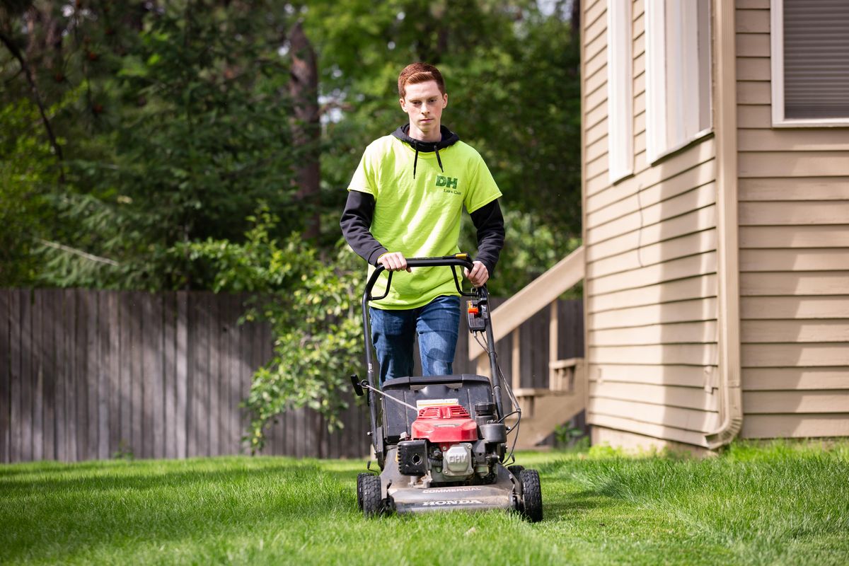 Kiefer McConnell, 16, one of six full-time employees of DH Lawn Care, services a South Hill backyard on July 10, 2019. (Libby Kamrowski / The Spokesman-Review)