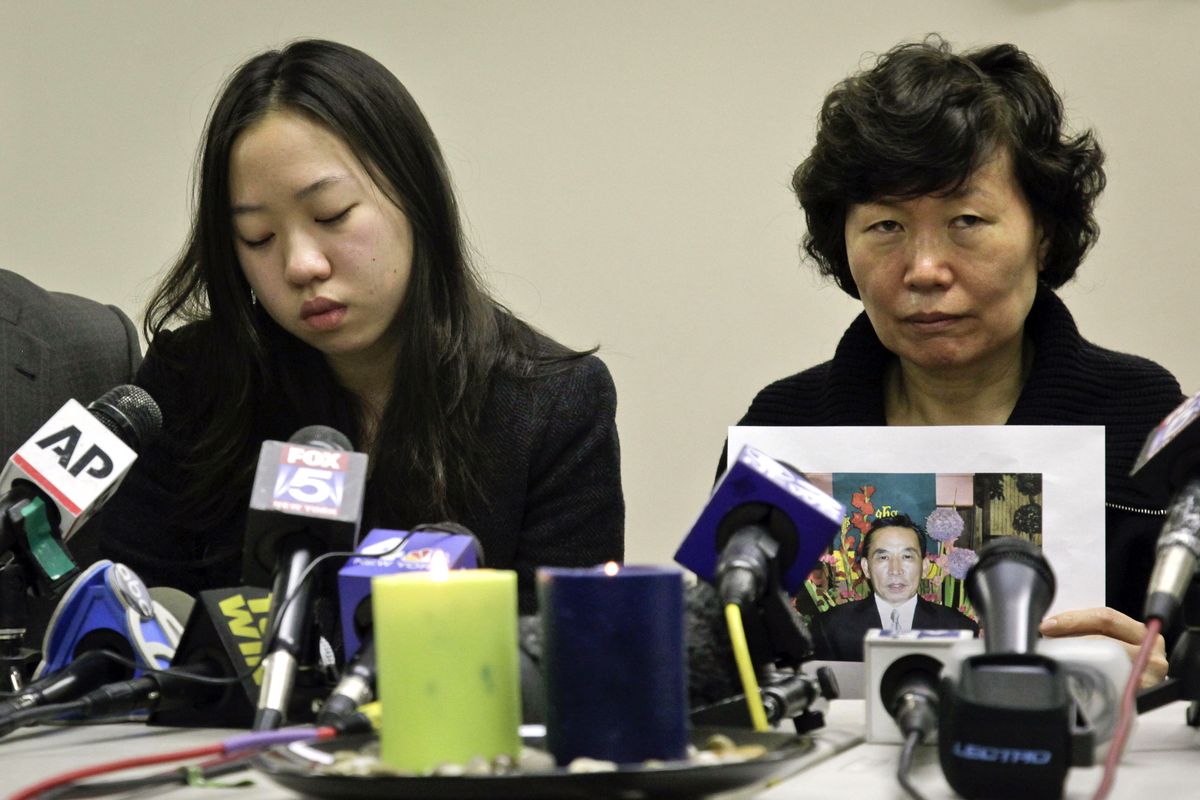 Serim Han , right, holds a picture of her husband Ki-Suck Han as she sits next to their daughter Ashley Han, 20, during a news conference on Wednesday, Dec. 5, 2012 in New York. A homeless man was arrested Wednesday in the death of Ki-Suck Han, who was pushed onto the tracks and photographed just before a train struck him. (Bebeto Matthews / Associated Press)