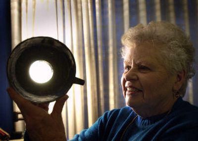 
Doris Brown of Spokane holds her mother's graniteware funnel, which dates to the early 1900s. 
 (Brian Plonka / The Spokesman-Review)
