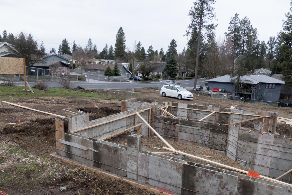 The foundation of a triplex apartment house takes shape on a rocky lot at 29th Avenue and Perry St. on the South Hill, shown Tuesday, April 9, 2018. The lot is rocky and sloping and previously unbuilt. (Jesse Tinsley / The Spokesman-Review)