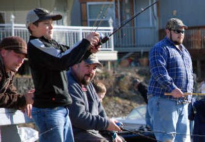 Daniel Moreno, 13, of Spokane, captures the attention of anglers on the dock at Williams Lake as he hooks a rainbow trout Saturday morning, opening day of Washington's lowland fishing season.
(Rich Landers / The Spokesman-Review)