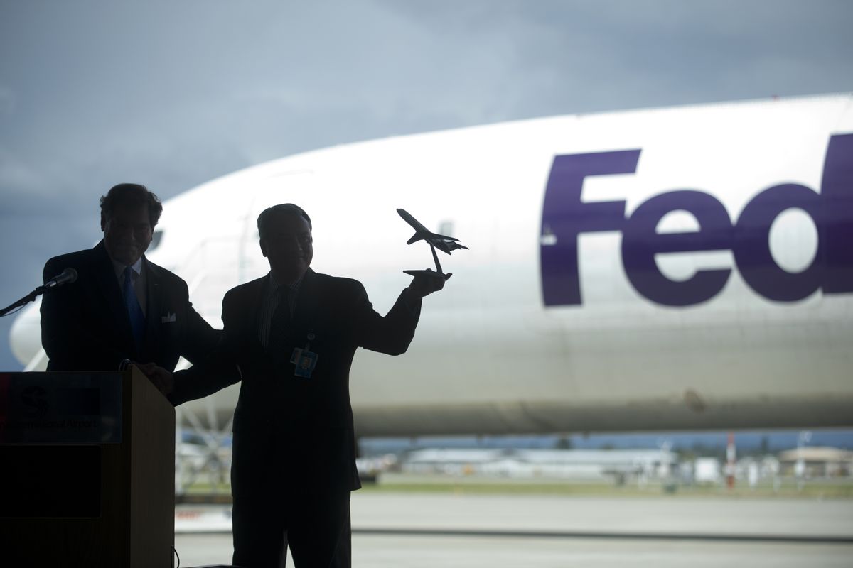 Lawrence Krauter, the Spokane International Airport director, holds a model Boeing 727 given to him by David Sutton, managing director of aircraft sales and acquisitions with FedEx, after Sutton presented the airport with a 727 air frame. (PHOTOS BY TYLER TJOMSLAND)