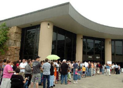 
Visitors line up to enter the Creation Museum in Petersburg, Ky., which opened to the public Monday.  The museum, which tells the Bible's version of Earth's history – that the planet was created in a single week just a few thousand years ago – attracted thousands to its opening. 
 (Associated Press photos / The Spokesman-Review)
