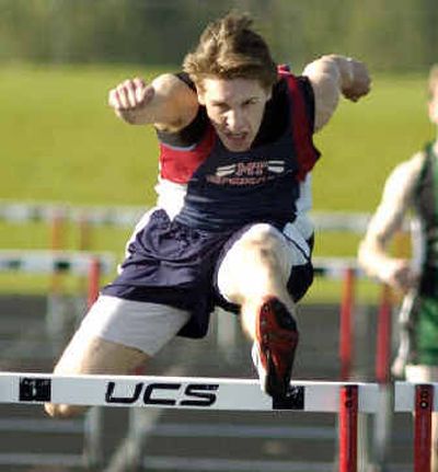 
In the 300-meter low hurdles, Mt. Spokane's Adam Barkley heads over the final hurdle to win the event.
 (Colin Mulvany / The Spokesman-Review)