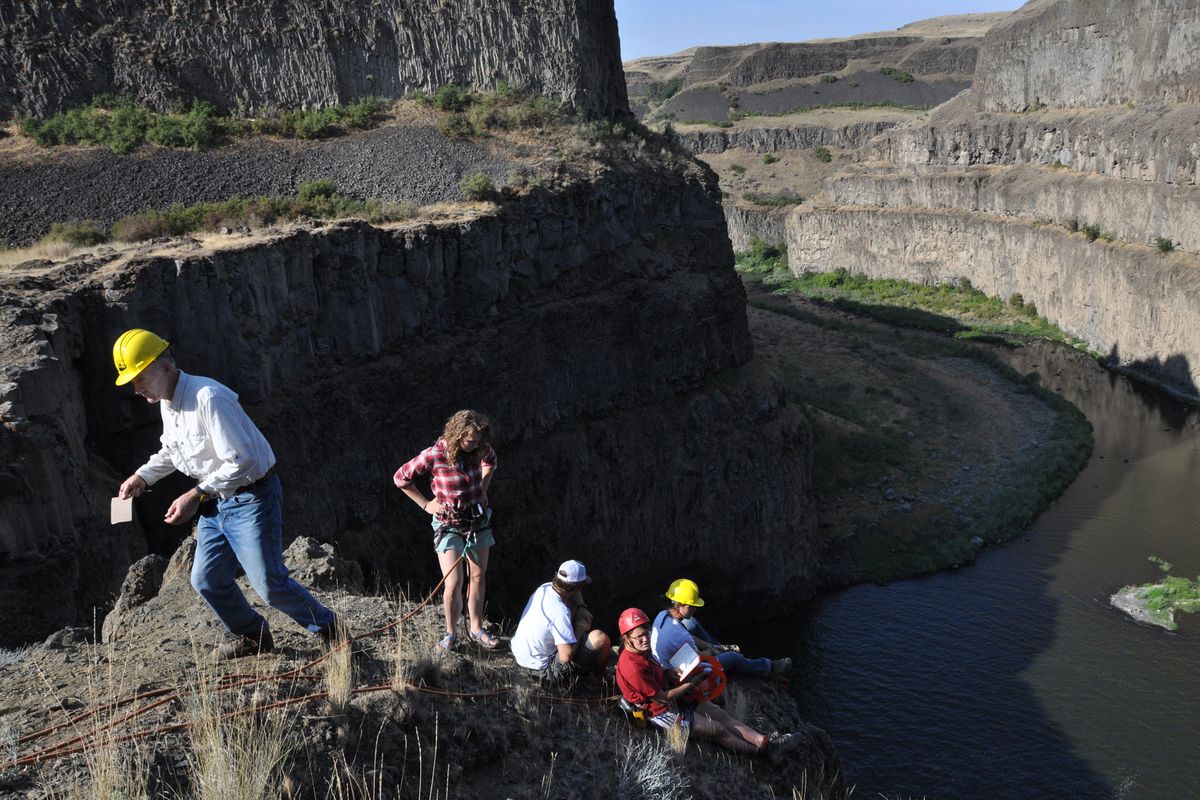 Bob Carson, Whitman College geology professor, left, records measurements taken by students on top of Palouse Falls (Rich Landers / The Spokesman-Review)