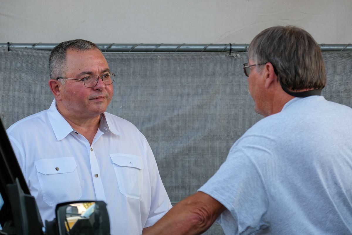 Loren Culp, running to represent Washington’s 4th district in Congress, talks to voter Ted Cantrell on Friday outside the Barn Door restaurant in Moxee, Wash.  (Orion Donovan-Smith/The Spokesman-Review)