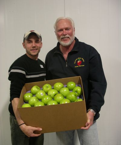 Second Harvest coordinator Keith Burgeson, left, and Bob Slyter, of Spokane Rotary West, hope apples from backyard fruit trees will fill food banks later in the summer. (PAT MUNTS)