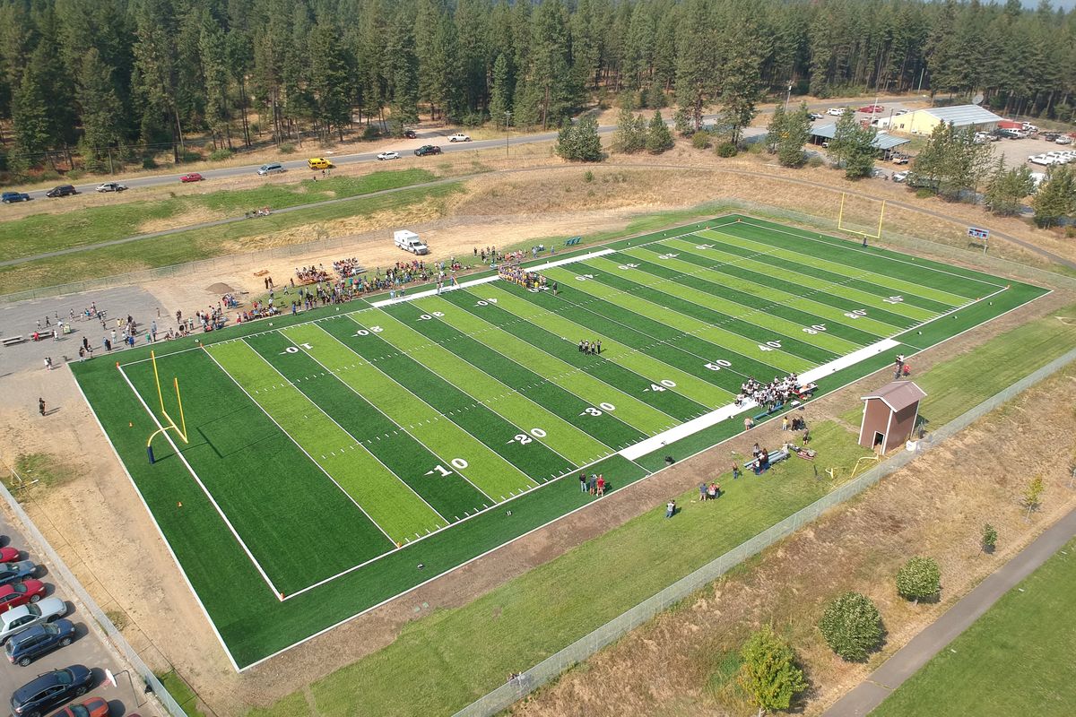 The permanently green football field at Wellpinit High School is courtesy of a grant from the National Football League, shown Friday, Sept. 9, 2022. The artificial turf makes Wellpinit the envy of tiny schools dotting Eastern Washington, where virtually every field is brown and dead by September. Wellpinit hosted the first game on the field Friday.  (Jesse Tinsley/THE SPOKESMAN-REVIEW)