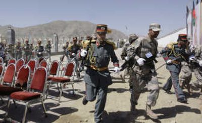 
Soldiers advance after a gunbattle during a ceremony Sunday in Kabul marking the 16th anniversary of the defeat of the Soviets in Afghanistan. Associated Press
 (Associated Press / The Spokesman-Review)