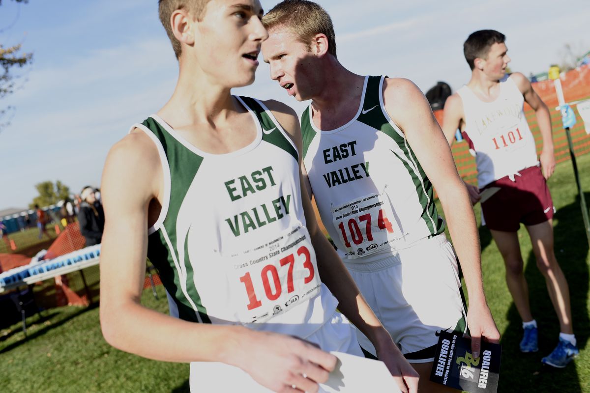 East Valley’s Chad Stevens, right, and teammate Scott Kopczynski, left, catch their breath after they finished first and third, respectively, in the 2A boys 2014 Washington State Cross Country meet on Saturday at Sun Willows Golf Course in Pasco. (PHOTOS BY TYLER TJOMSLAND)