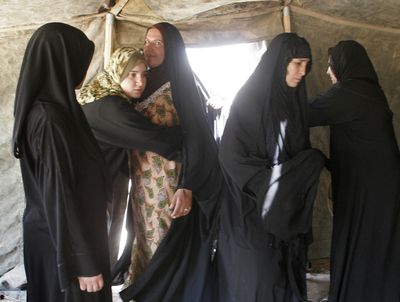 Iraqi policewomen search female Shiite pilgrims as they make their way to a major religious festival, in Latifiyah, about 30 kilometers (20 miles) south of Baghdad, in Iraq, Friday. (Associated Press / The Spokesman-Review)