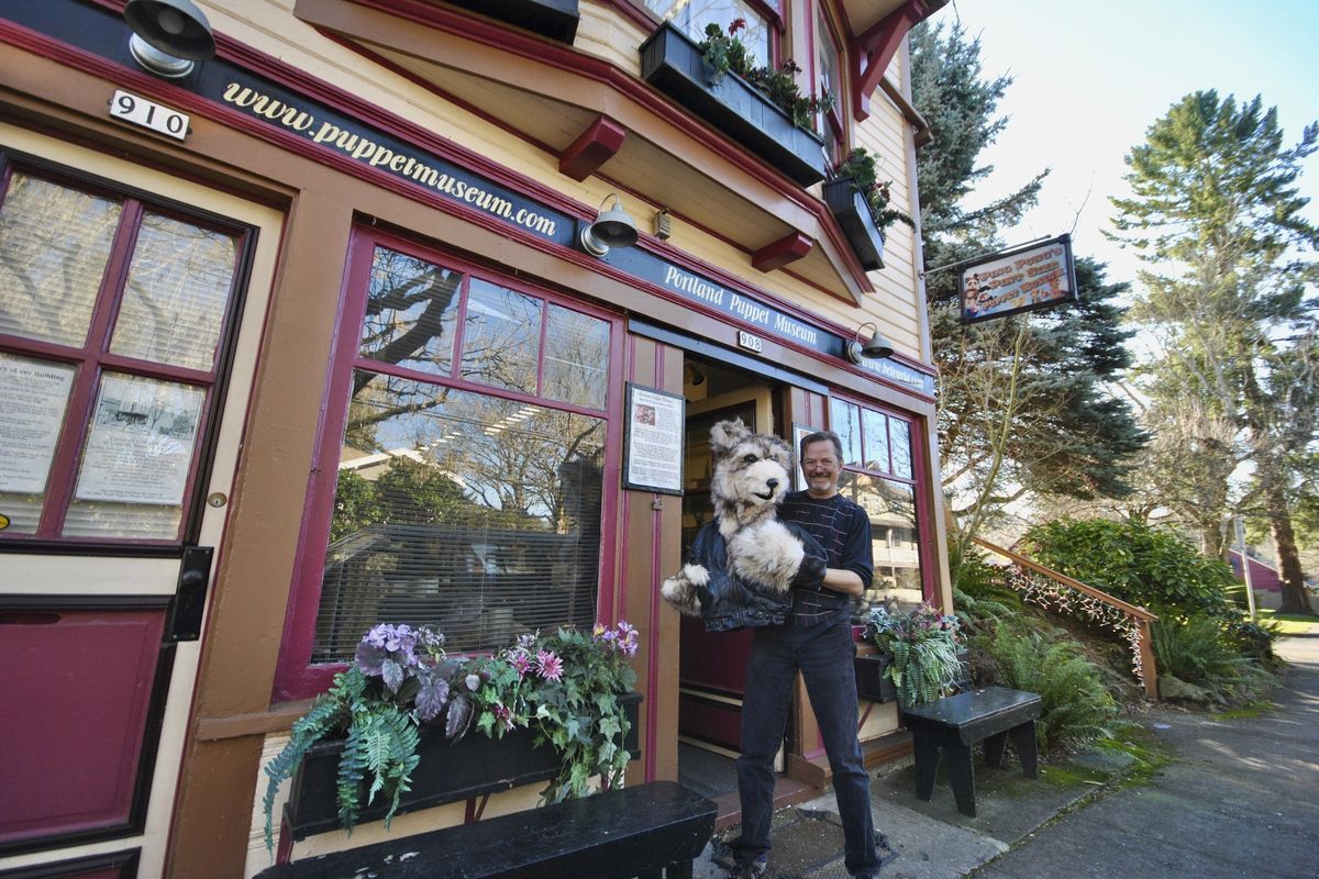 In this Tuesday, Feb. 13, 2018 photo, Steven M. Overton poses with the Big Bad Wolf outside his Portland Puppet Museum in Sellwood, Ore. (Samantha Swindler / Oregonian)
