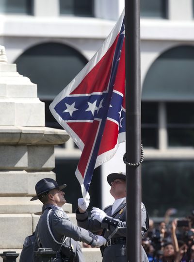 A highway patrol honor guard removes the Confederate battle flag from the Capitol grounds in Columbia, S.C., on Friday. (Associated Press)