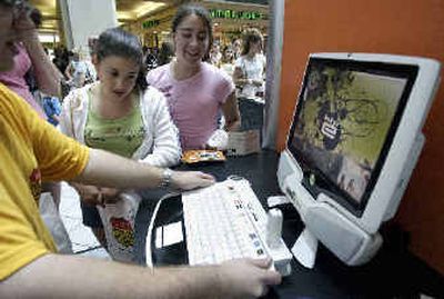 
Three students watch a demonstration of a hip-e computer at a shopping mall in North Attleboro, Mass. The hip-e is designed to serve as a hub for all of a teenager's digital interactions.
 (Associated Press / The Spokesman-Review)