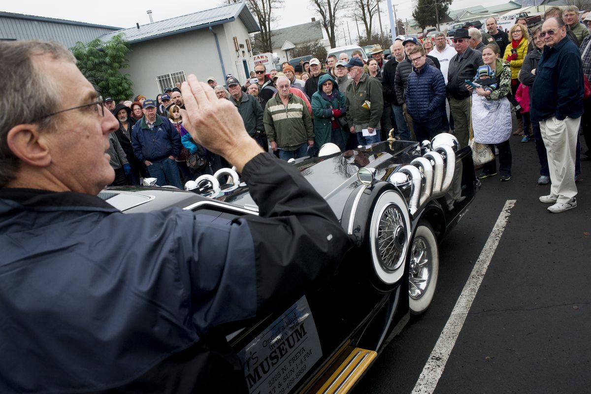Auctioneer Jeff Owens auctions one of Marvin Carr’s One of a Kind in the World Museum’s cars, a 1979 Lincoln, on Saturday in Spokane. Jerry Nebel, seen at center in green jacket with white stripes, had the winning bid for the car. (Tyler Tjomsland)