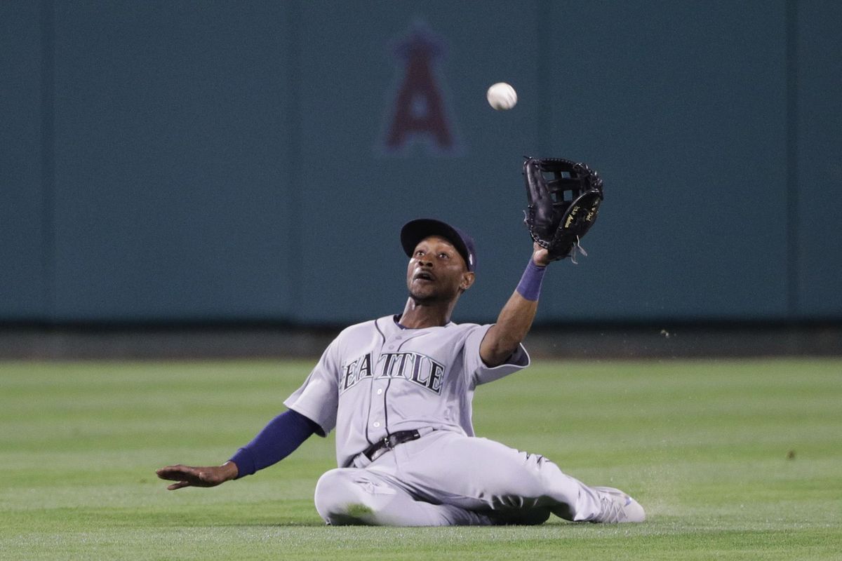 Seattle Mariners’ Jarrod Dyson catches a fly ball hit by Los Angeles Angels’ Albert Pujols during the fifth inning. He then doubled up Mike Trout at first, who took off on a hit-and-run. (Jae C. Hong / Associated Press)