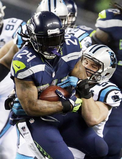 Seattle Seahawks running back Marshawn Lynch (24) runs against Carolina Panthers middle linebacker Luke Kuechly during the first half of an NFL divisional playoff football game in Seattle last Jan. 10. Both are returning from injuries and will likely meet up a time or two on Sunday. (AP Photo/John Froschauer) (John Froschauer / Associated Press)